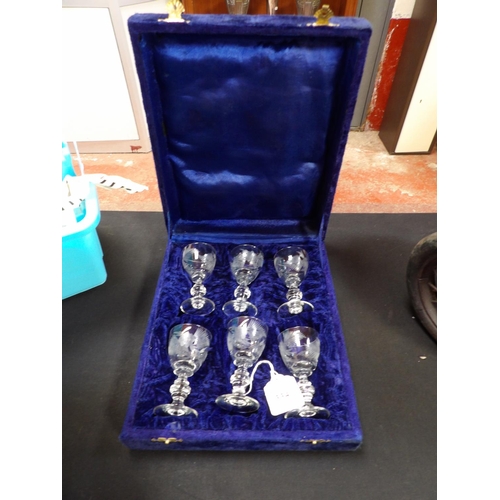 334 - A cased set of six stemmed liqueur glasses with acid etched decoration