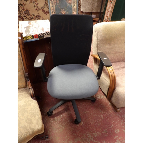 344 - A revolving office chair upholstered in grey coloured fabric