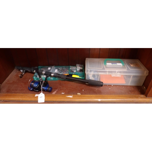 445 - A telescopic fishing rod fitted a new reel together with a fishing tackle box and an assortment of f... 