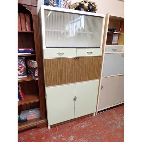 447 - A mid century part glazed fall front kitchen cabinet