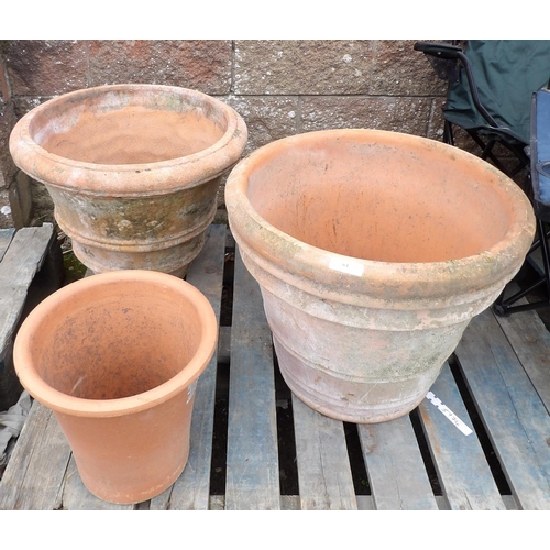 61 - Two terracotta planters of large proportion together with one other