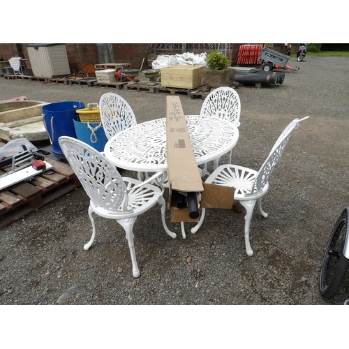 91 - A pierced metallic oval patio table together with four matching chairs and a parasol
