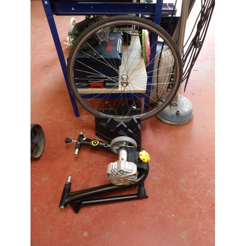 162 - A CycleOps turbo trainer, a triangulated bicycle stand, a bicycle wheel and two tyres