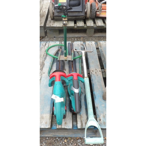 102 - Two Bosch cordless hedge cutters, a garden fork and an irrigation sprinkler