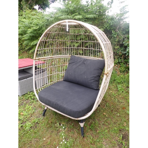 26 - A exterior wicker egg chair the cushions upholstered in charcoal coloured fabric