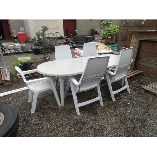 50 - A PVC extending patio table together with five chairs