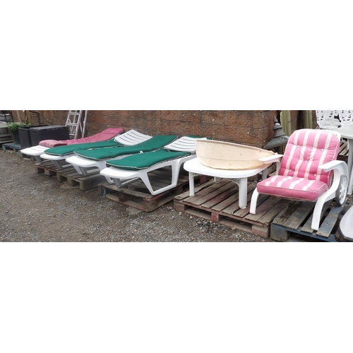 63 - Four Hartman white PVC sun loungers and cushions together with a similar armchair, table etc.