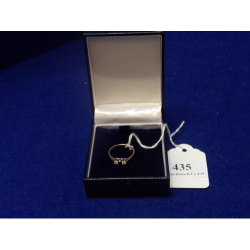 435 - A 9 carat yellow gold ring set with two diamonds and a sapphire size N