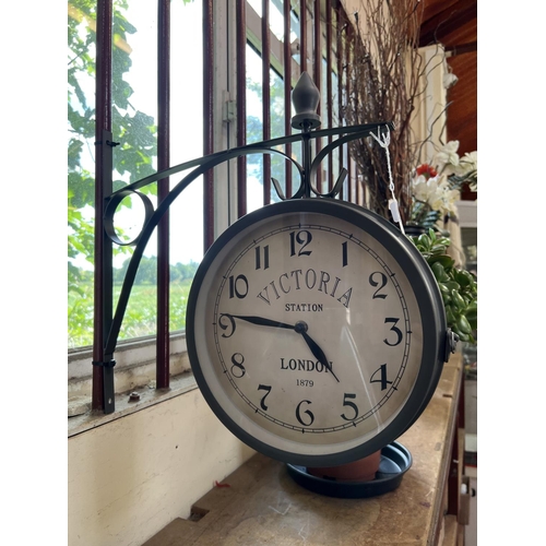 161 - A suspended wall clock and bracket inscribed Victoria Station, London 1879