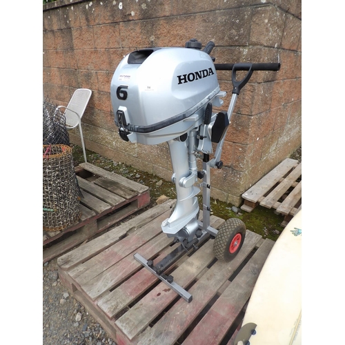 54 - A Honda 6hp outboard engine mounted upon a bespoke trolley