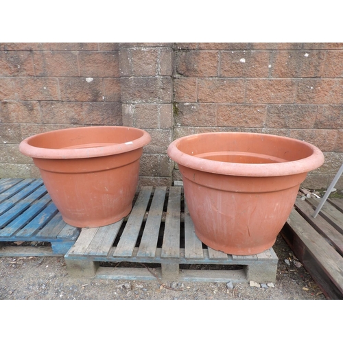 57 - A pair of terracotta effect planters of enormous proportion 60cm high x 85cm diameter