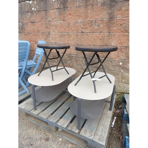 58 - A pair of oval patio tables each fitted an under tier together with a pair of metallic folding patio... 