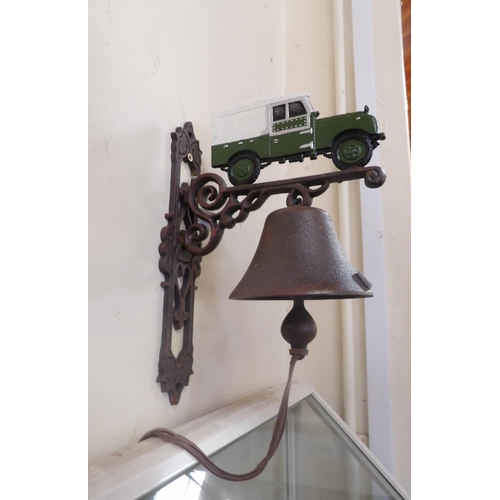 173 - A cast iron wall mounted bell and bracket with Land Rover decoration