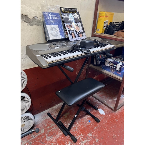 335 - A Yamaha EZ-250i electronic keyboard, stand, stool and accessories