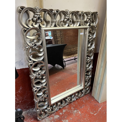 381 - A large ornate rectangular silver gilt framed bevelled wall mirror