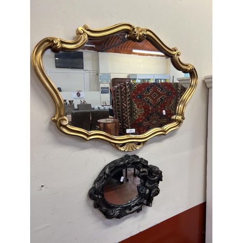 414 - A gilt framed mirror together with another mirror with cherub decoration