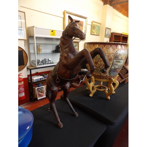 254 - A vintage leather sculpture of a prancing horse