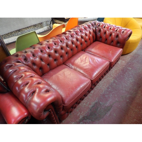 271 - A Chesterfield settee upholstered in red coloured leather