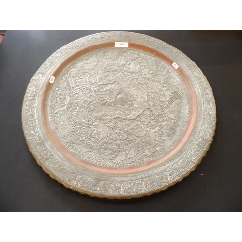 279 - An oriental copper charger of circular form with silvered decoration