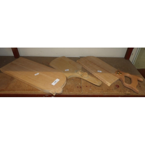 144 - Three wooden cheese boards, two in the Mouseman style the other as a hand saw