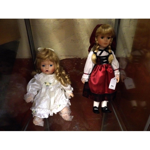 254 - Two porcelain faced dolls