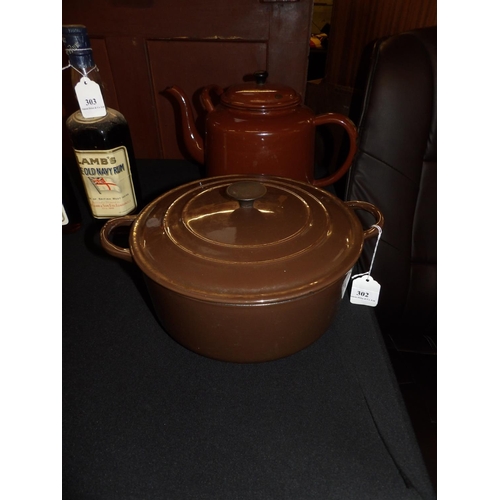 302 - A Le Creuset cast iron casserole dish together with a vintage enamelled tea pot