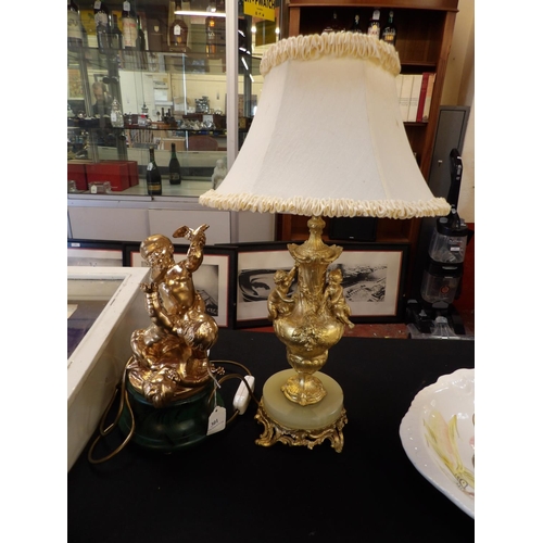 301 - A gilded centre piece depicting three playful cherubs together with an onyx and gilt table lamp with... 