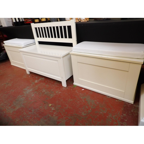 330 - A pair of storage boxes finished in white and complete with cushions together with a similar storage... 