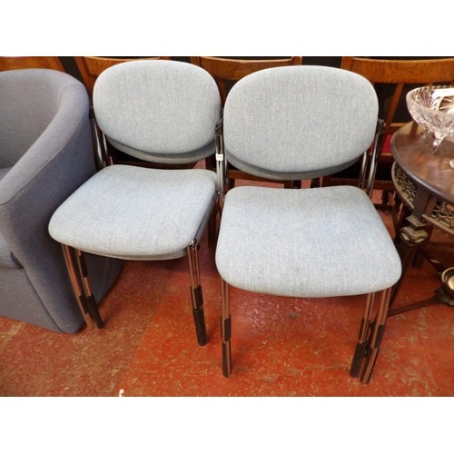 334 - A set of four chrome framed stacking conference chairs upholstered in turquoise coloured fabric