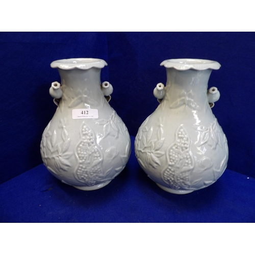 412 - A pair of Chinese Celadon glazed vases with Pomegranate decoration in relief