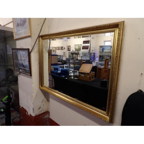 425 - A rectangular gilt framed bevelled wall mirror