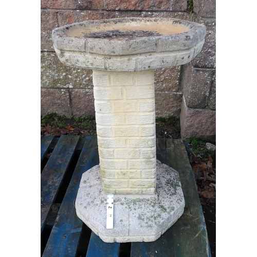 39 - A reconstituted stone bird bath the column modelled in the form of bricks