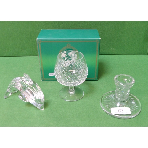 121 - Three pieces of Waterford crystal, a brandy glass, a candle stick holder and a model of a dolphin