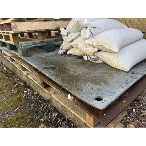 22 - Several sand bags together with two sheets of reinforced PVC checker plate together with a sheet of ... 