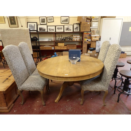 269 - A light oak single pedestal circular breakfast table together with four high back chairs fully uphol... 