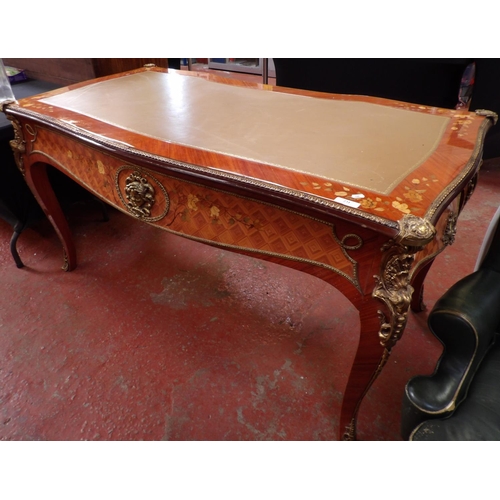 231 - A continental fruitwood bureau plat with profuse marquetry and ormolu decoration, the top inlaid wit... 