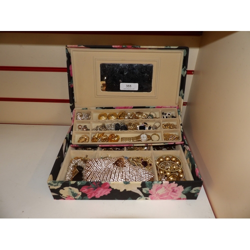 355 - A jewellery chest containing a vast accumulation of jewellery and wrist watches