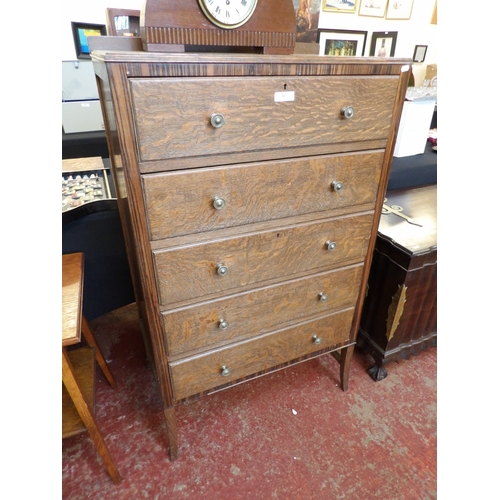 367 - A 1930s oak chest of five long reverse graduated drawers