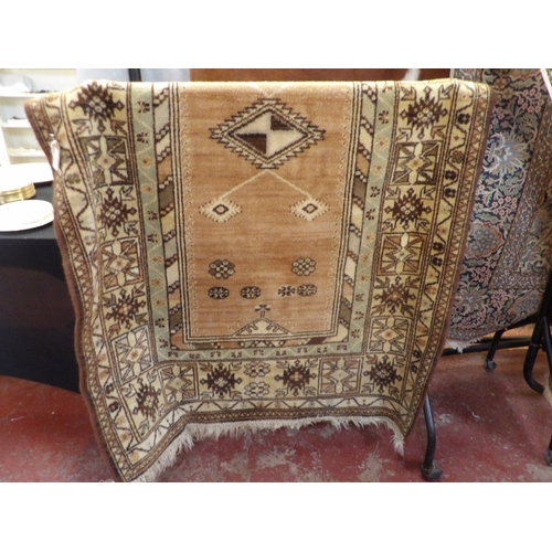 386 - A Turkish floor rug decorated with geometric designs on a brown and green coloured ground 2.35m x 1.... 