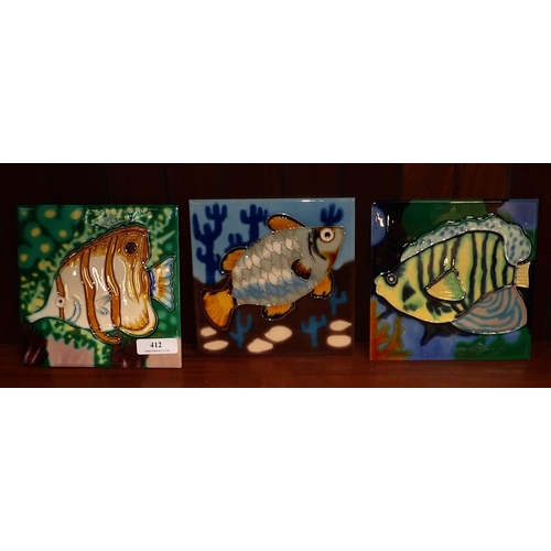 412 - Three majolica tube lined tiles depicting fish