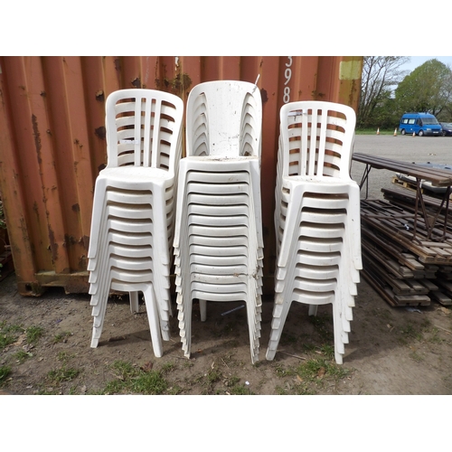 Thirty two white PVC stacking chairs