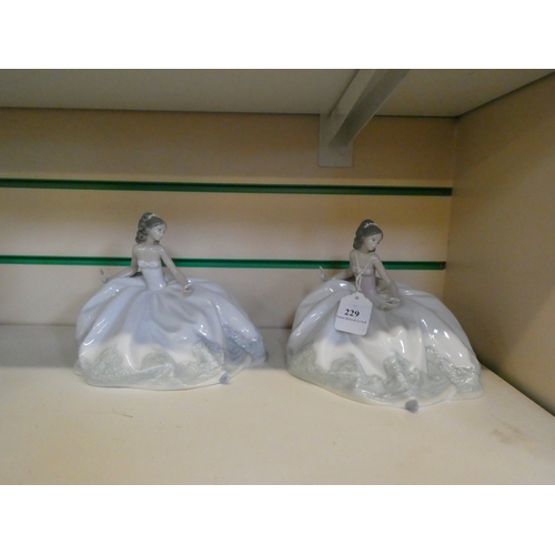229 - Two Lladro models of women in ballgowns clutching fans