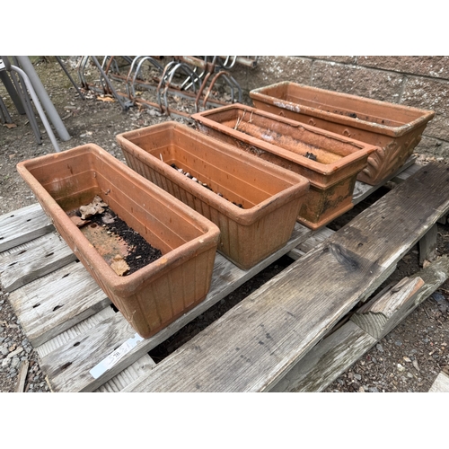 70 - Four terracotta flower troughs