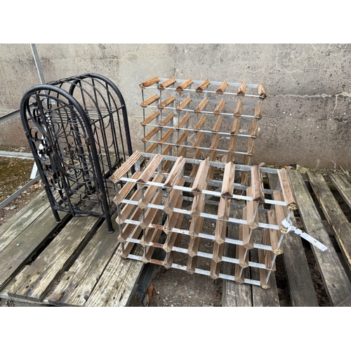 79 - A wrought metal wine cabinet of arched form together with two wooden and metallic wine racks