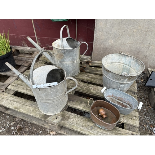 85 - Two vintage galvanised watering cans, a pail etc.