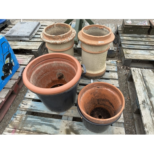 92 - A pair of terracotta chimney pots together with four planters
