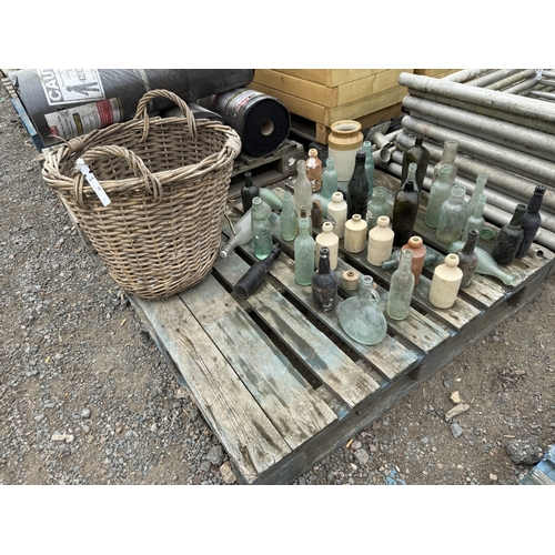 95 - A collection of vintage bottles and jars together with a vintage cabot basket