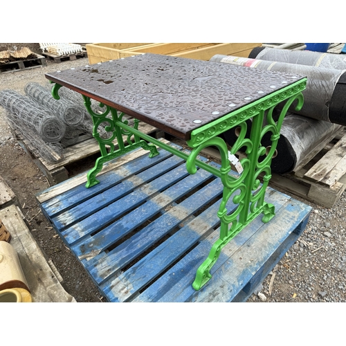 97 - A cast metallic and wooden garden table modelled in the Victorian style