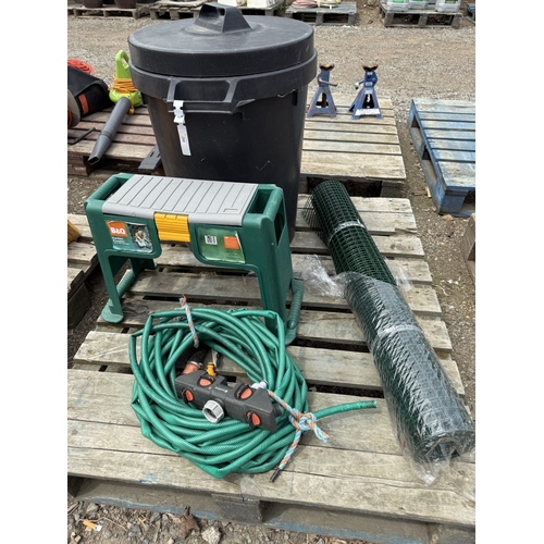 102 - A garden kneeler, a hose pipe and attachments, a roll of garden mesh and a dustbin
