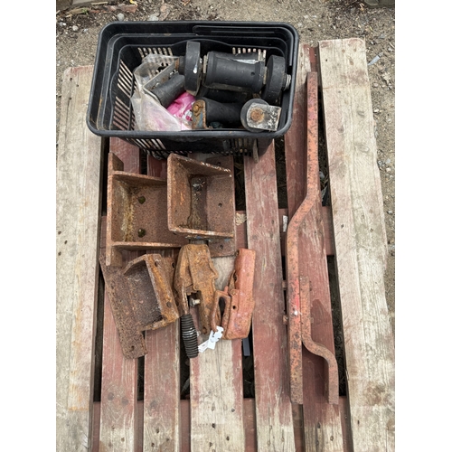 109 - A tractor draw bar, two ball hitches, various brackets and trailer accessories
